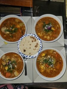 Assorted Salvadoran dishes including handmade pupusas, tamales, fried yuca, and plantains served fresh at Pupusería Patty’s