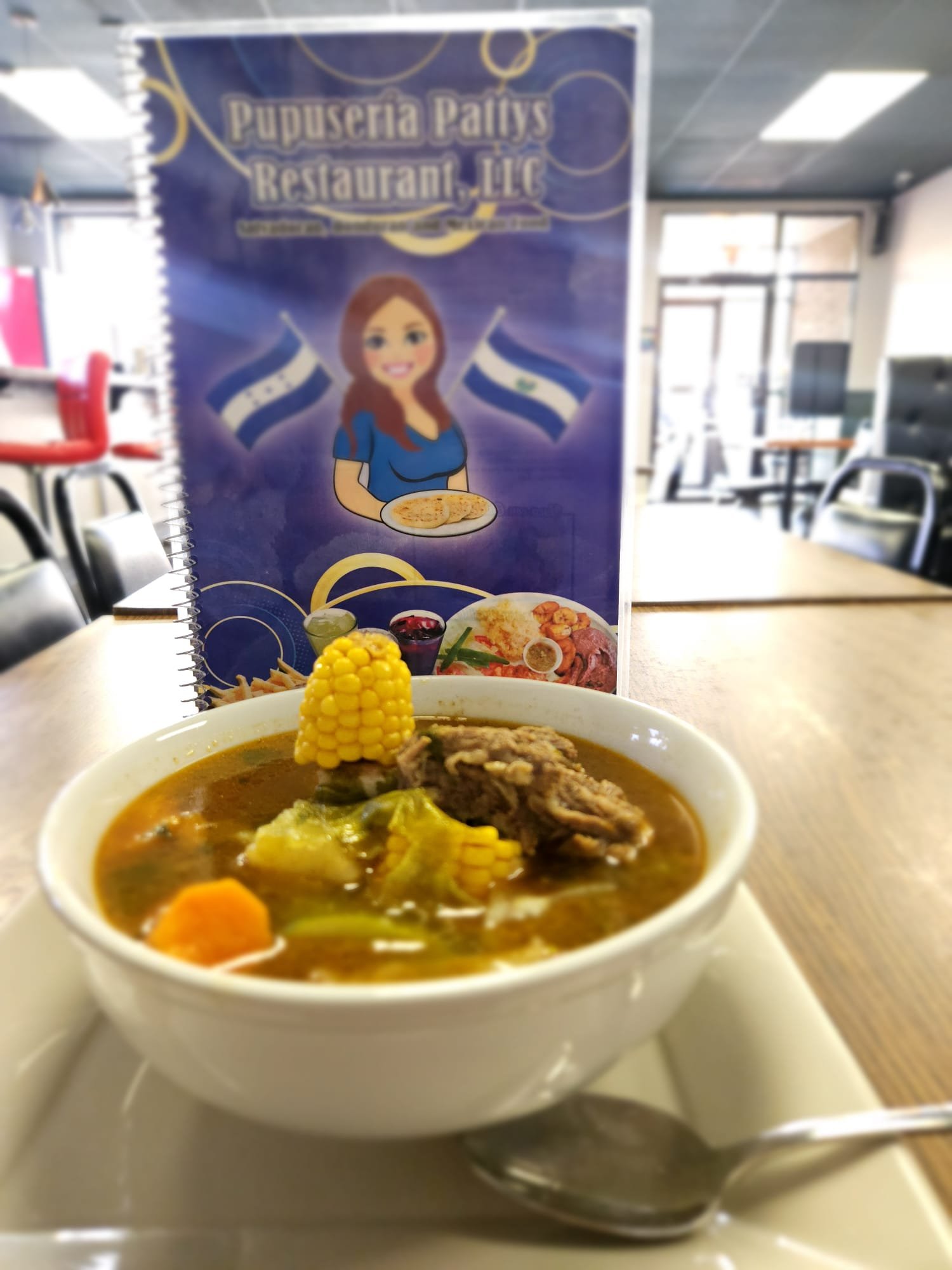 Assorted Salvadoran dishes including handmade pupusas, tamales, fried yuca, and plantains served fresh at Pupusería Patty’s