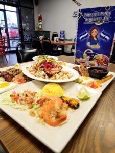 Assorted Salvadoran dishes including handmade pupusas, tamales, fried yuca, and plantains served fresh at Pupusería Patty’s