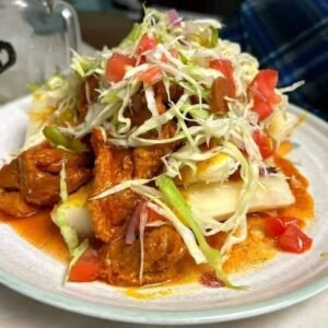 Assorted Salvadoran dishes including handmade pupusas, tamales, fried yuca, and plantains served fresh at Pupusería Patty’s