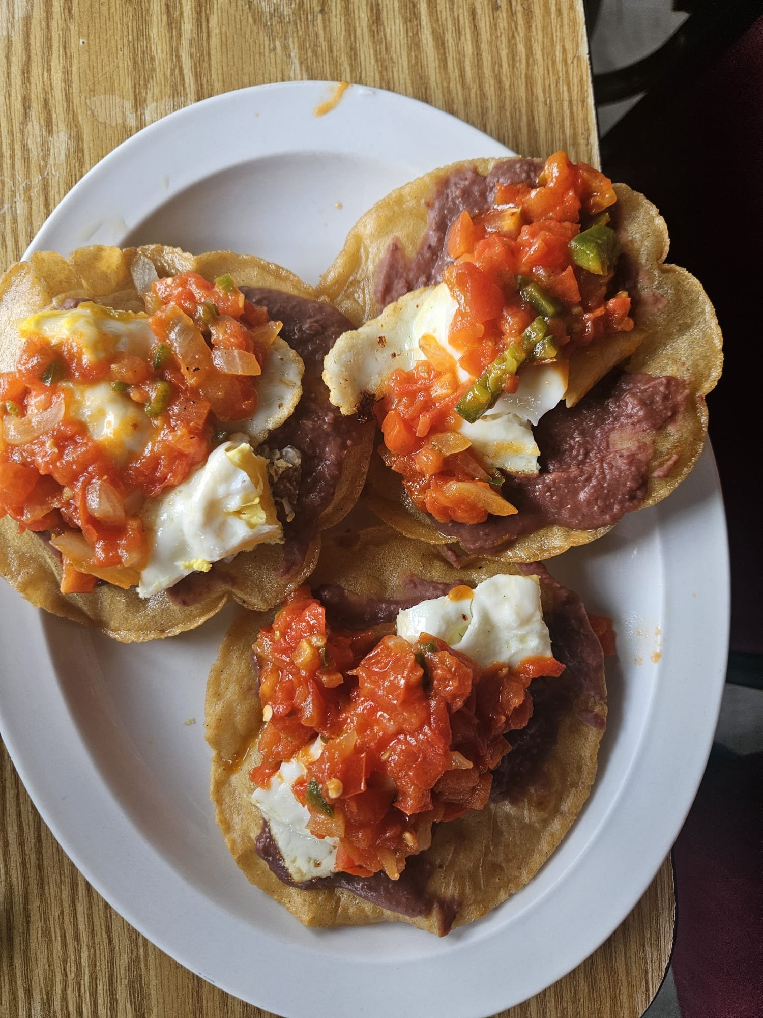 Assorted Salvadoran dishes including handmade pupusas, tamales, fried yuca, and plantains served fresh at Pupusería Patty’s