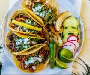 Assorted Salvadoran dishes including handmade pupusas, tamales, fried yuca, and plantains served fresh at Pupusería Patty’s