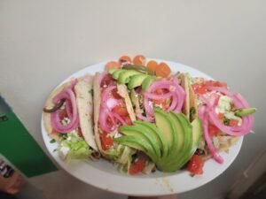 Assorted Salvadoran dishes including handmade pupusas, tamales, fried yuca, and plantains served fresh at Pupusería Patty’s