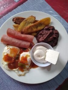 Assorted Salvadoran dishes including handmade pupusas, tamales, fried yuca, and plantains served fresh at Pupusería Patty’s