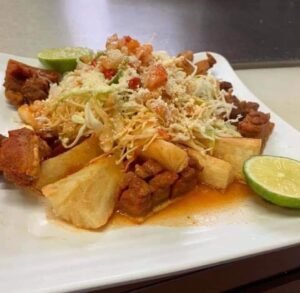 Assorted Salvadoran dishes including handmade pupusas, tamales, fried yuca, and plantains served fresh at Pupusería Patty’s