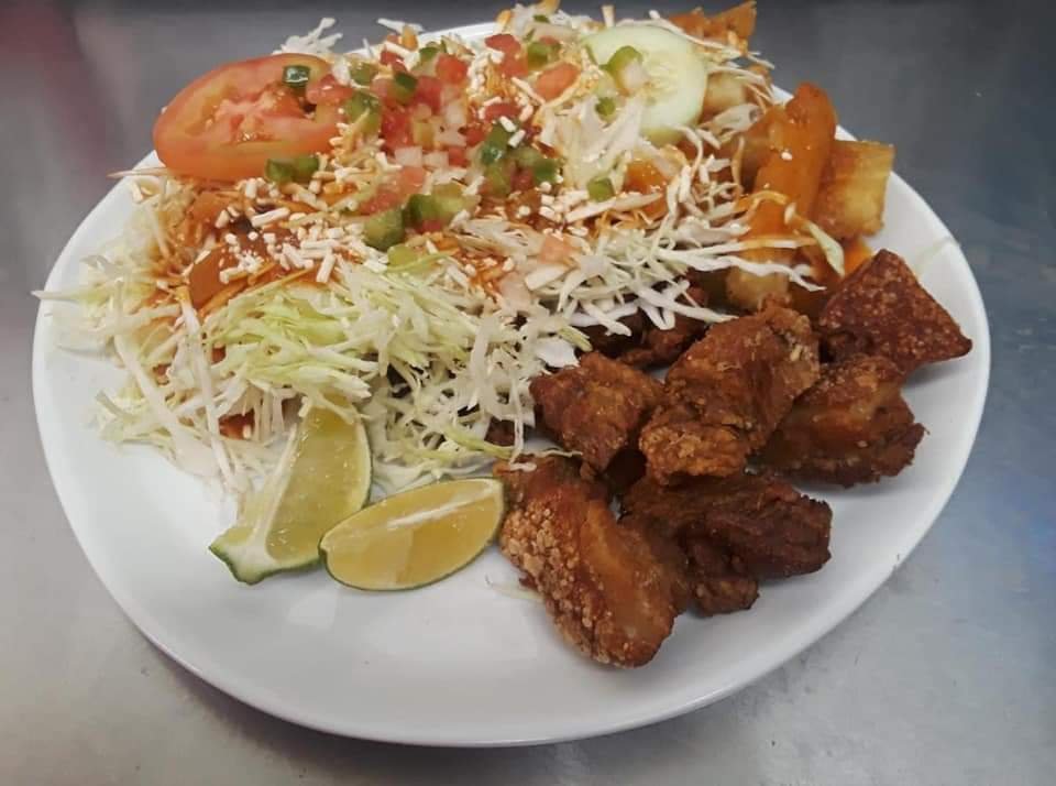 Assorted Salvadoran dishes including handmade pupusas, tamales, fried yuca, and plantains served fresh at Pupusería Patty’s