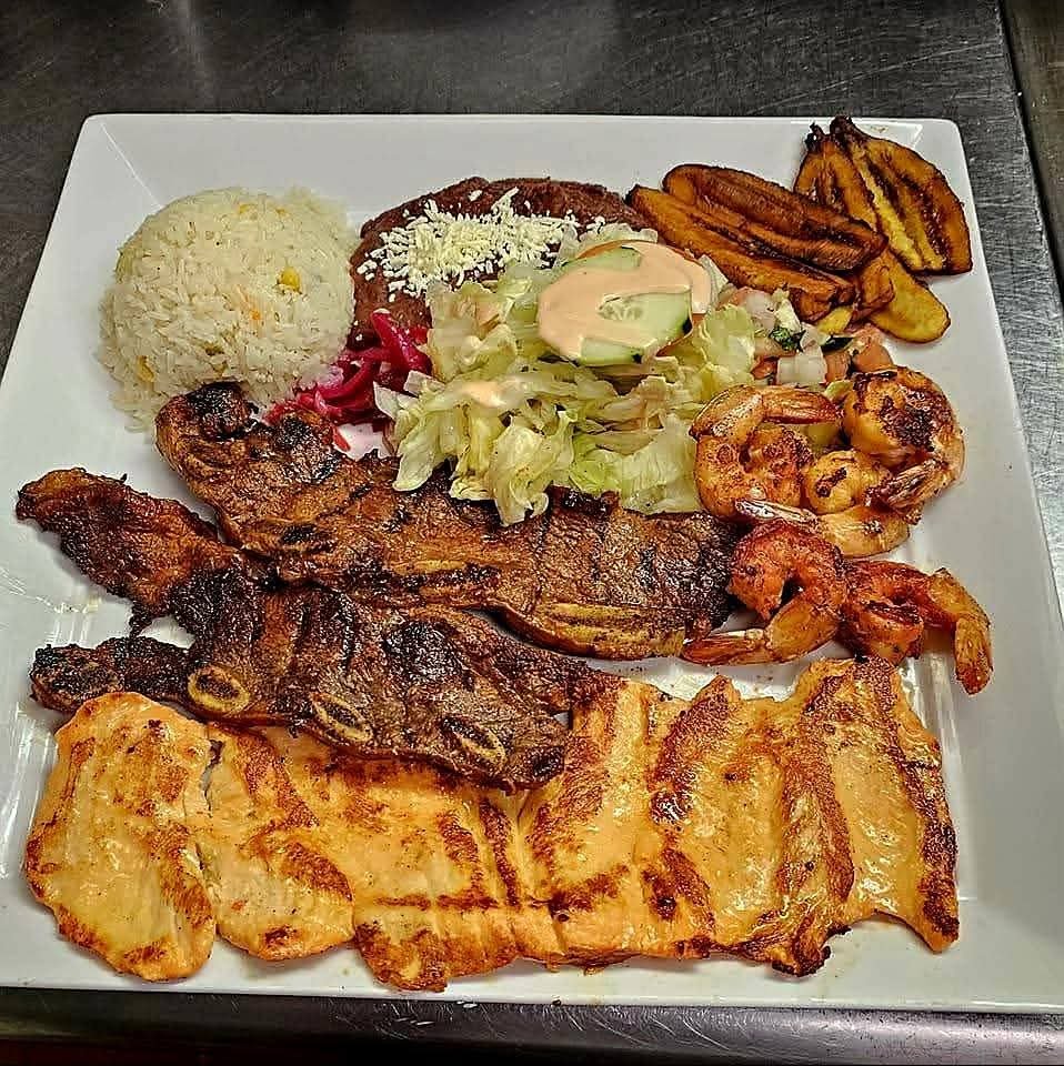 Assorted Salvadoran dishes including handmade pupusas, tamales, fried yuca, and plantains served fresh at Pupusería Patty’s