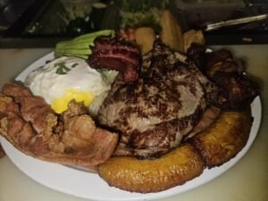 Assorted Salvadoran dishes including handmade pupusas, tamales, fried yuca, and plantains served fresh at Pupusería Patty’s