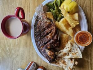 Assorted Salvadoran dishes including handmade pupusas, tamales, fried yuca, and plantains served fresh at Pupusería Patty’s
